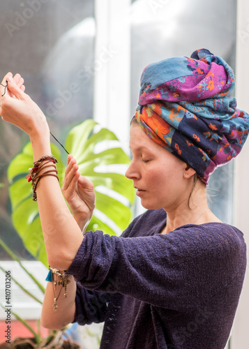 Photography young woman in turban and bracelets doing spiritual practice