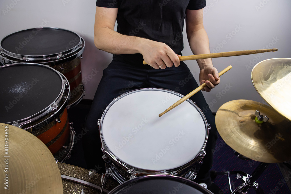 Fototapeta premium Professional drum set closeup. Man drummer with drumsticks playing drums and cymbals, on the live music rock concert or in recording studio &nbsp;