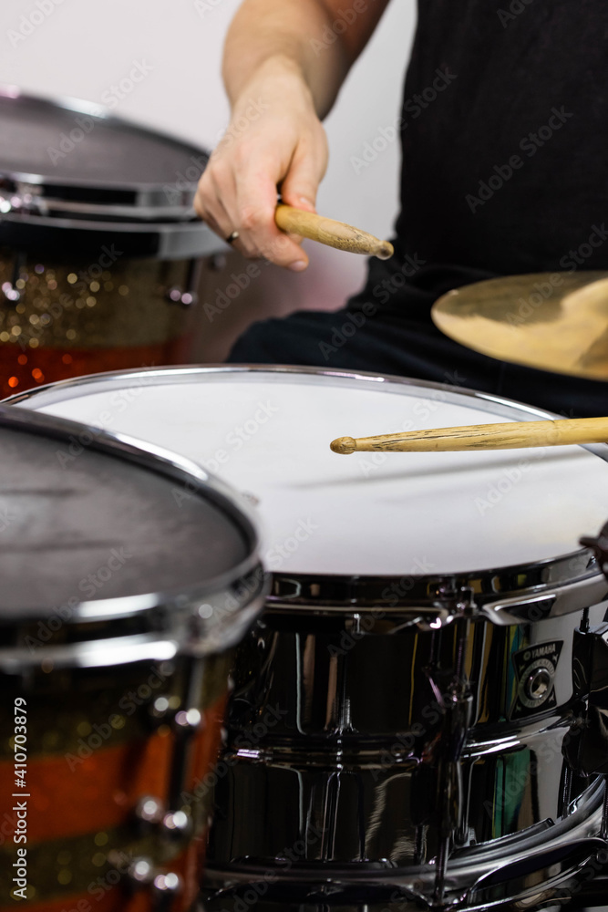 Professional drum set closeup. Man drummer with drumsticks playing drums and cymbals, on the live music rock concert or in recording studio Professional drum set closeup. Man drummer with drumsticks playing drums and cymbals, on the live music rock concert or in recording studio