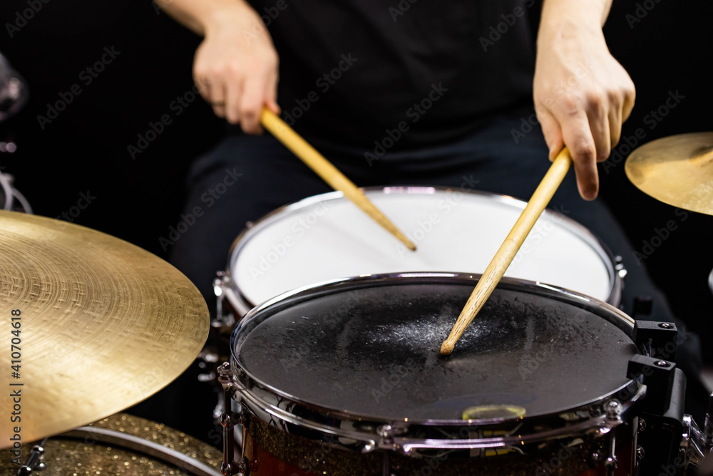 Obraz premium Professional drum set closeup. Man drummer with drumsticks playing drums and cymbals, on the live music rock concert or in recording studio &nbsp;