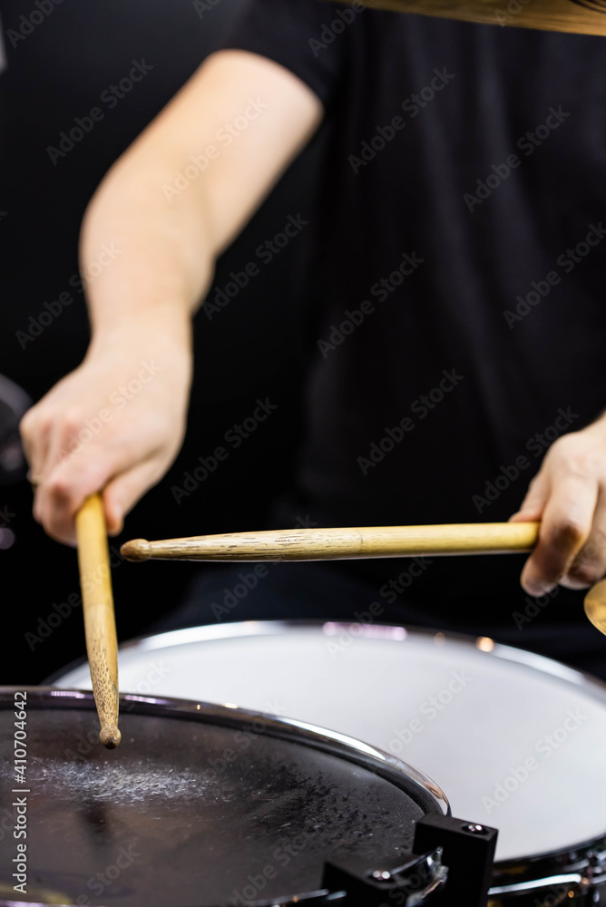 Professional drum set closeup. Man drummer with drumsticks playing drums and cymbals, on the live music rock concert or in recording studio Professional drum set closeup. Man drummer with drumsticks playing drums and cymbals, on the live music rock concert or in recording studio