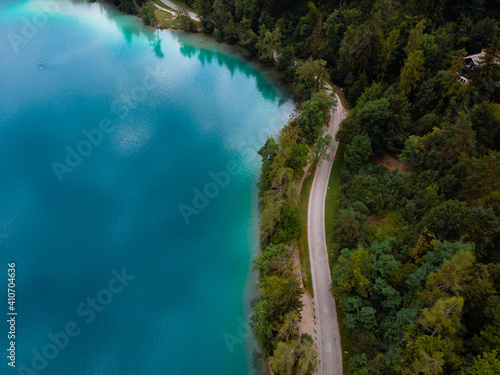Aerial top down panoramic view of Lake Bled road and cars. Cloudy weather. Summer day. Season of tour and travel. Triglav, Slovenia, Europe