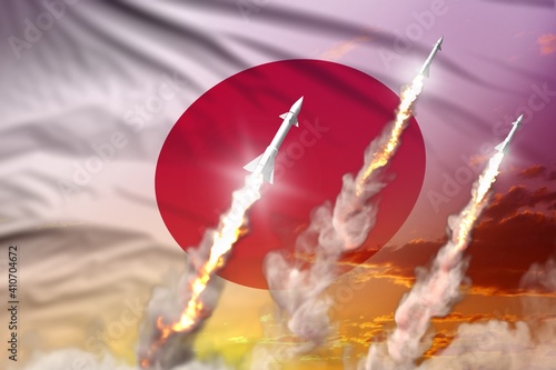 Japan nuclear missile launch - modern strategic nuclear rocket weapons concept on sunset background, military industrial 3D illustration with flag photo