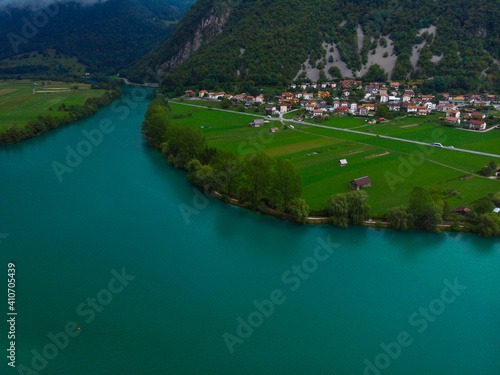 Aerial view of Most Na Soci lake in beautiful colors near Tolmin in Slovenia. Summer cloud day. Travel and vacation. Copy space photo