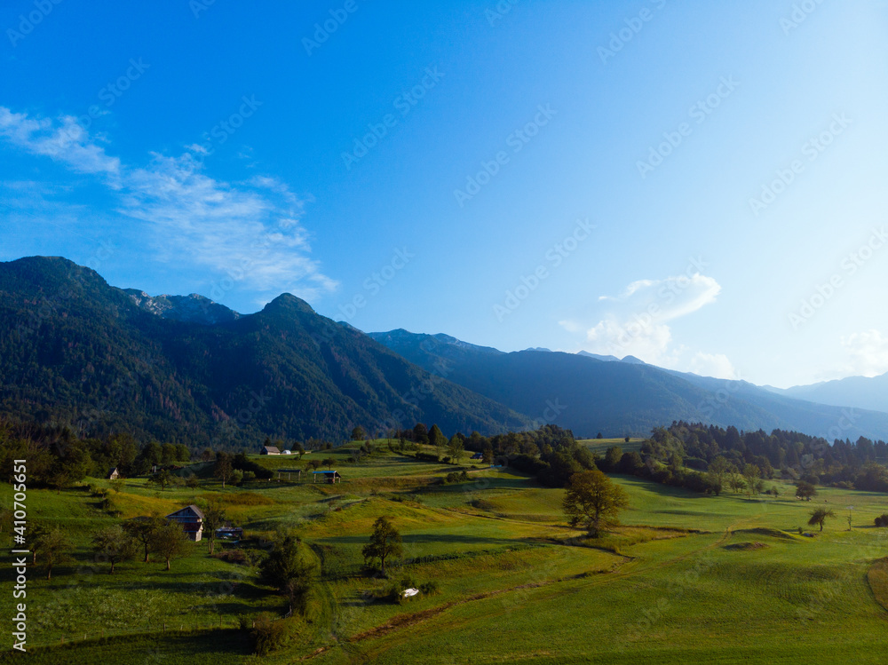 Aerial view. Mountains, road, summer day sunset. Travel and tourism. green hills. Bohinjska Bistrica Slovenia, Triglav