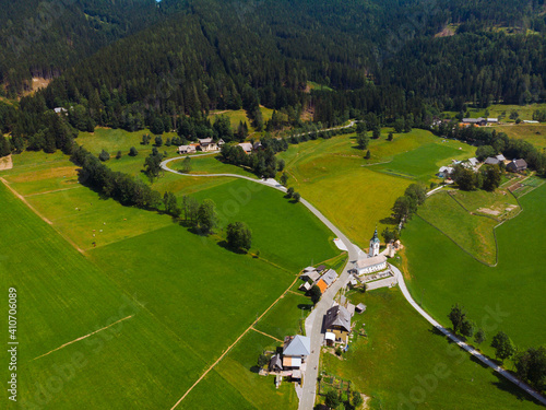 Aerial view over green meadow in Zgornje Jezersko, to Kamnik-Savinja Alps on a sunny summer day in Slovenia. Travel and tourism. photo