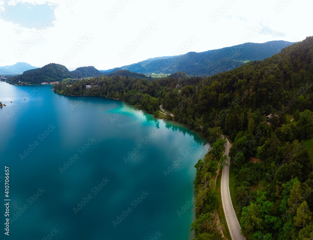 Aerial panoramic view of Lake Bled. Cloudy weather, heavy thunderstorm clouds on the horizon. Summer day. Season of tour and travel. Triglav, Slovenia, Europe