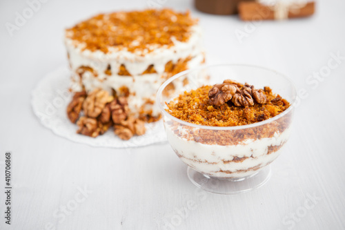 portioned homemade cake dessert with honey and walnuts on a light background