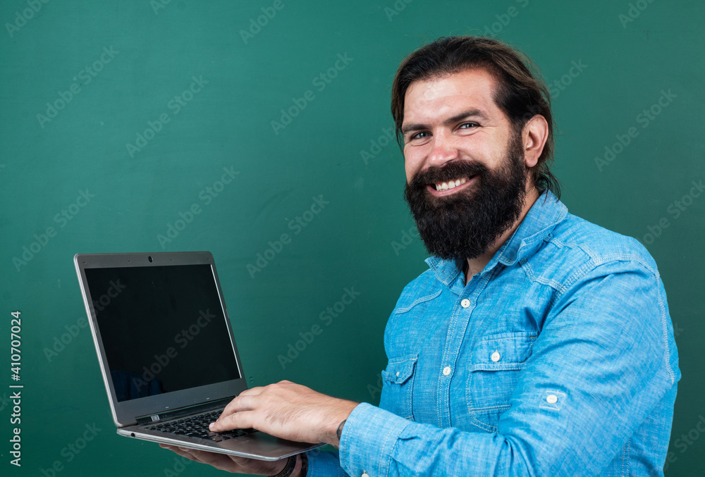 cheerful successful and confident man with beard working on laptop online, technology cheerful successful and confident man with beard working on laptop online, technology