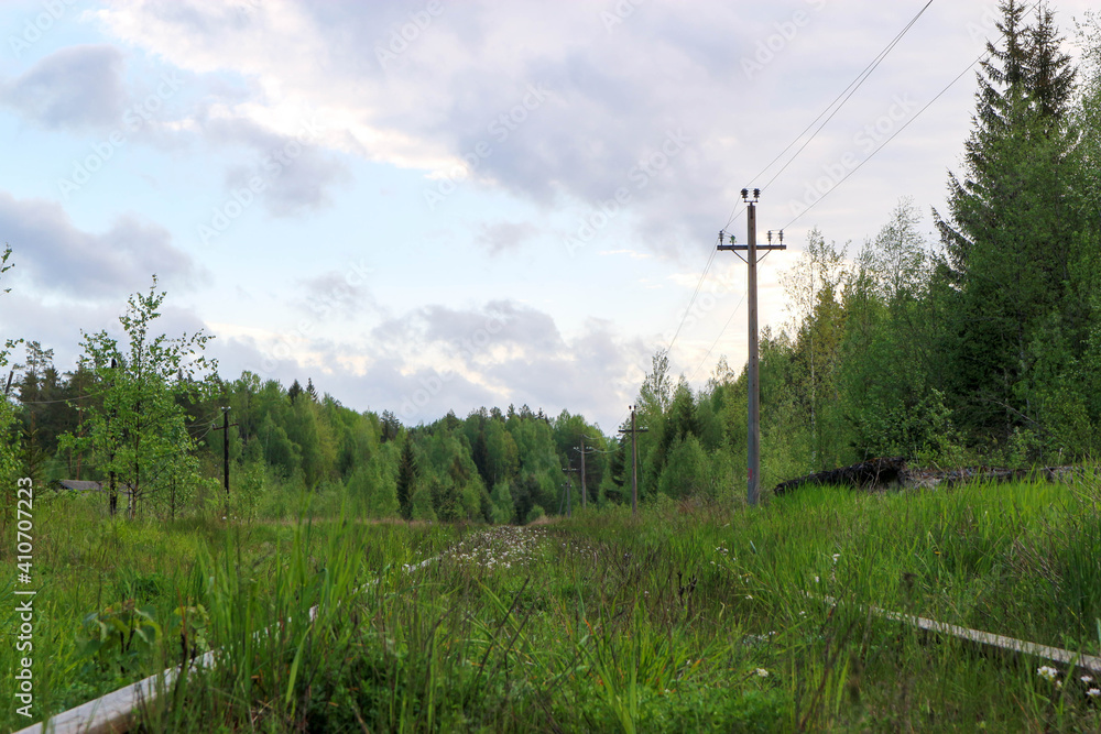 beautiful view of old abandoned railway surrounded by green spring forest in russian outback