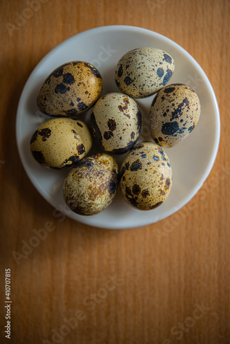 quail eggs in a plate stand on the table surface indoors.