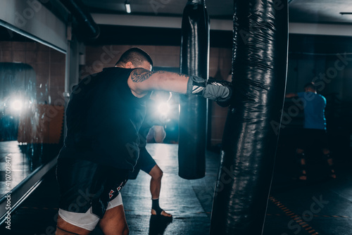 Portrait of boxer training with gloves and boxing equipement