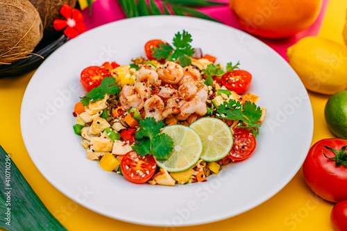healthy food, salad with shrimps and vegetables with rice on a decorated table