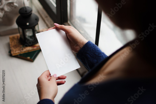 Woman looking at blank white sheet of paper template