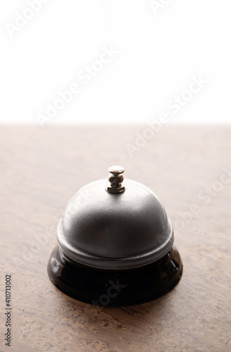 Close up of hotel bell on reception table, copy space