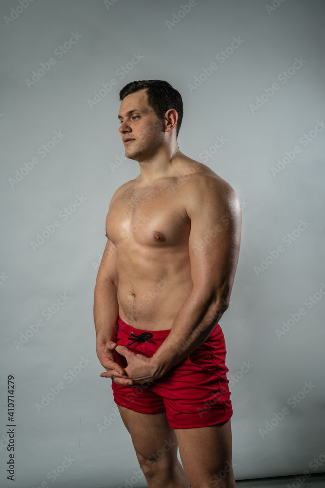 Fototapeta premium Fitness man shows off muscles on white background male businessman smart, young happy. trendy, trendy smile background black bodybuilder