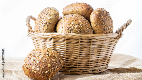 Home baked bread. Rye bakery with crusty loaves and crumbs. Fresh rustic traditional bread with wheat grain ear or spike plant on natural cotton background. Design element for bakery product label.