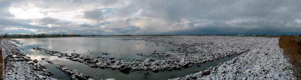 panorama of a plowed field in the snow with a stormy sky panorama of a plowed field in the snow with a stormy sky