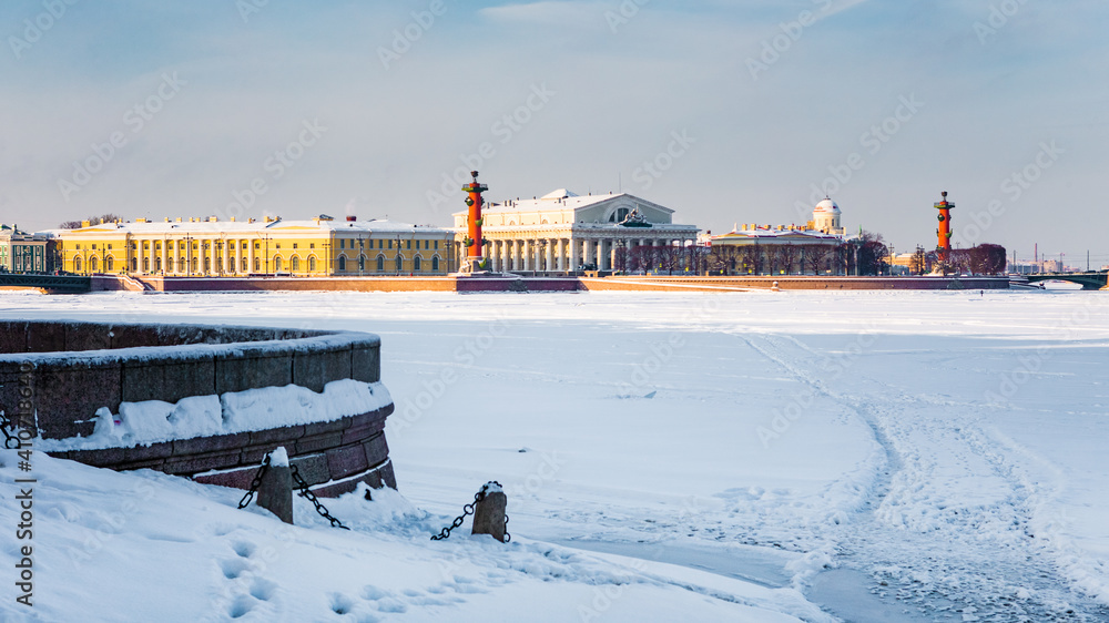 Roman-style columns - Rostralnaya Kolonna on Vasilyevsky island. Sights of St. Petersburg. Winter in the city on the Neva in Russia