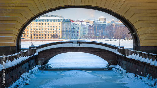 Arch and bridge connecting the Winter Canal and the Bolshaya Neva river. Sights of St. Petersburg. Winter in the city on the Neva in Russia
