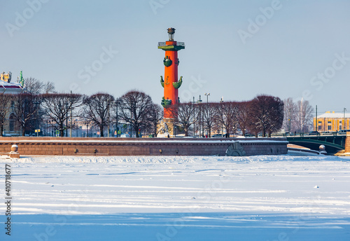 Roman-style columns - Rostralnaya Kolonna on Vasilyevsky island. Sights of St. Petersburg. Winter in the city on the Neva in Russia photo
