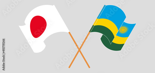 Crossed and waving flags of Japan and Rwanda