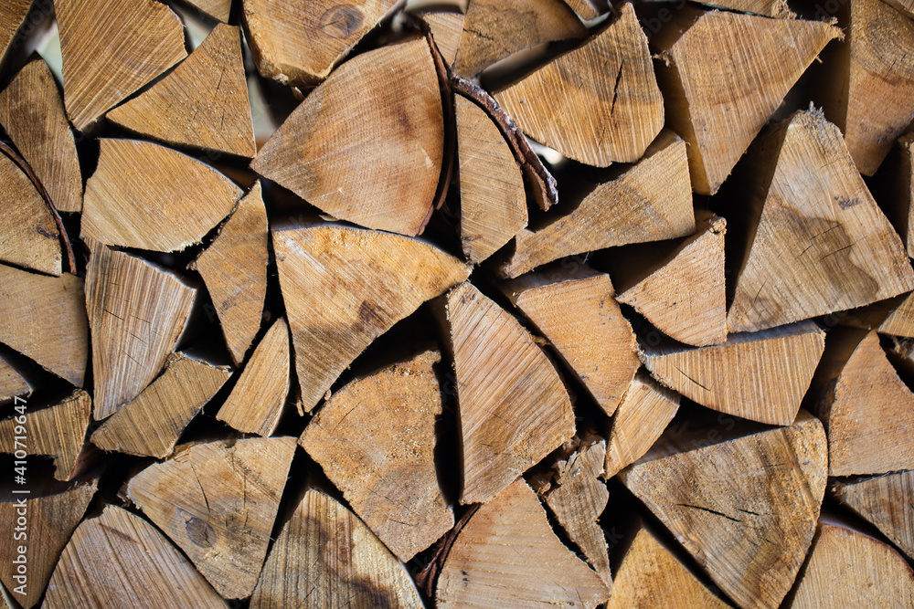 Stacked firewood close-up. Firewood storage close up. Stocks of wooden logs close-up. Chopping wood. Logging in the village. Stacked firewood close-up. Firewood storage close up. Stocks of wooden logs close-up. Chopping wood. Logging in the village.