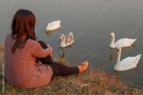 A girl on a swan lake photo