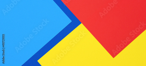 Creative abstract blue, red and yellow color geometric paper compositon background, top view