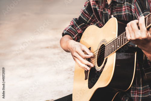 Close up a man's hands playing acoustic guitar. Playing acoustic guitar at a recording studio.