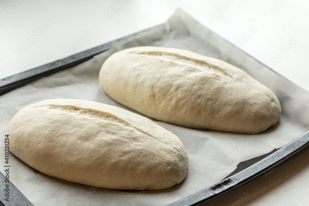 Yeast buns on a baking sheet