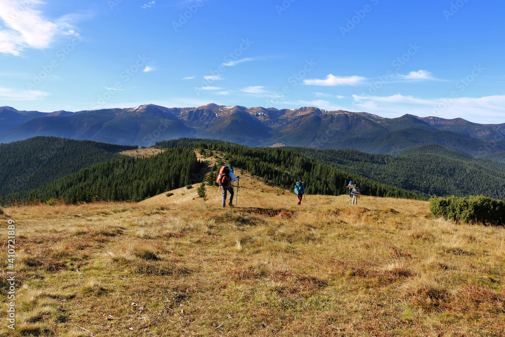 tourists walk along the mountain ranges