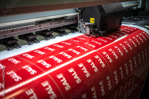 Full-color printing on the machine of the sticker with the inscription sale