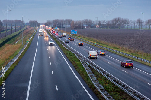 Cars driving in the evening on the A44 highway to the village of Sassenheim, Abbenes and Kaag in the Netherlands. photo