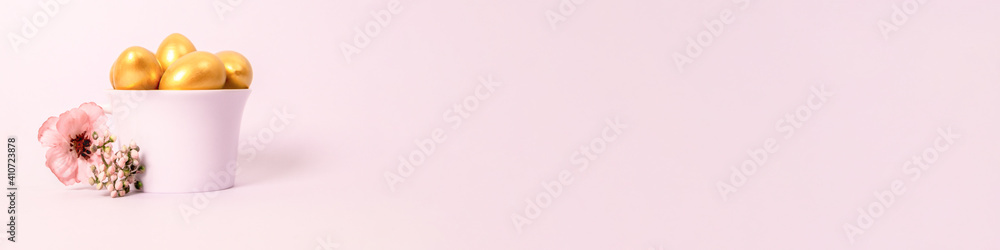 Easter composition of golden decorative and quail eggs in porcelain cups on a pink background. Selective focus, copy space. Banner. Easter composition of golden decorative and quail eggs in porcelain cups on a pink background. Selective focus, copy space. Banner.