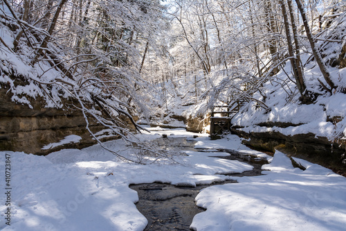 Morning light on a beautiful snowy winter landscape.  Matthiessen state park, Illinois, USA. photo