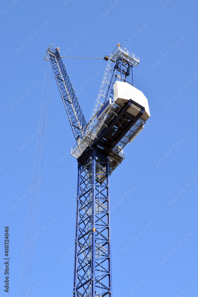 Tower Crane seen from below against Blue Sky 