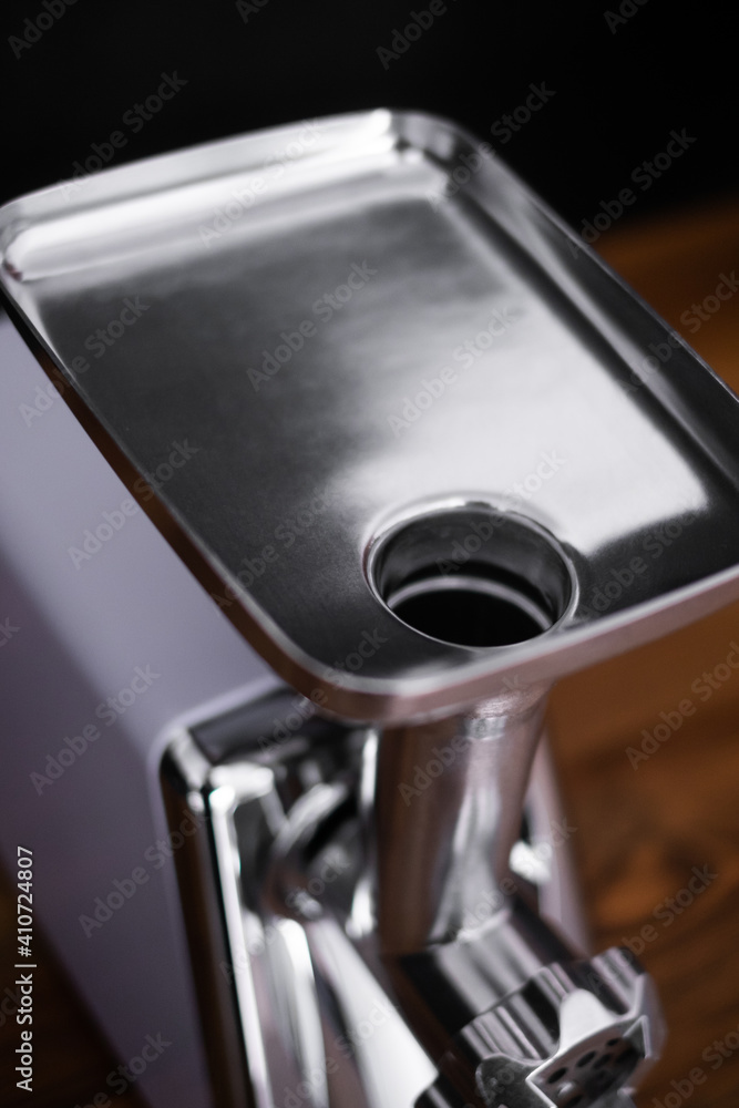 household electric meat grinder on a light gray background, different perspective positions. kitchen appliances. top view household electric meat grinder on a light gray background, different perspective positions. kitchen appliances. top view