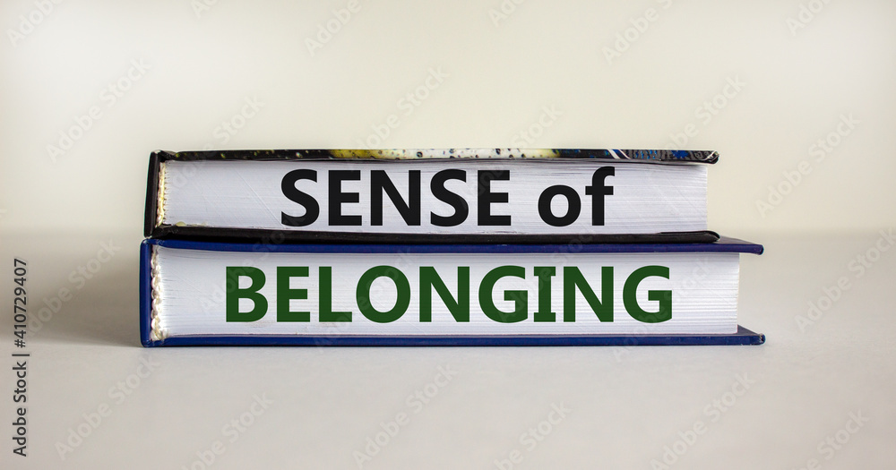 Sense of belonging symbol. Books with words 'sense of belonging' on beautiful white background. Business, sense of belonging concept. Copy space.