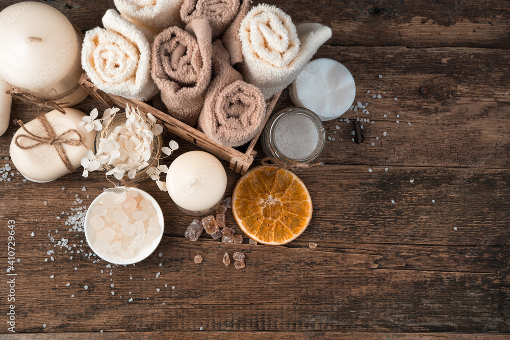 Spa composition with candles, soap and napkins on a brown wooden background. Top view, with space to copy. Spa composition with candles, soap and napkins on a brown wooden background. Top view, with space to copy.