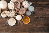Spa composition with candles, soap and napkins on a brown wooden background. Top view, with space to copy.
