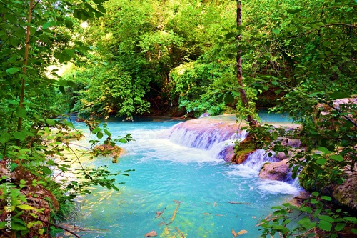 landscape of the Elsa river, known as the turquoise river, inside the river park in Siena in Tuscany, Italy. The blue color of the water is due to the thermal springs that feed it
