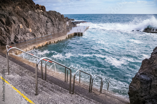 Stone pavement with railings descent to sea. photo