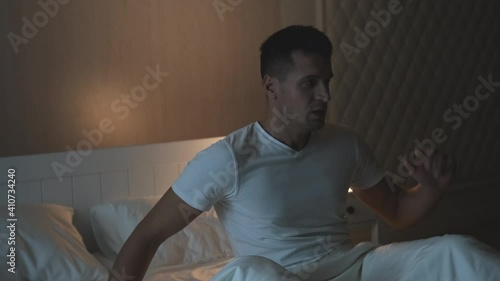 The handsome man wakes up after nightmare