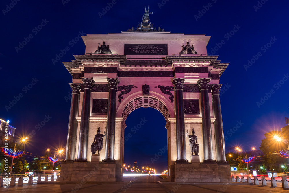 Triumphal Arch in Moscow on Kutuzovsky Prospekt at night with decorative lighting.