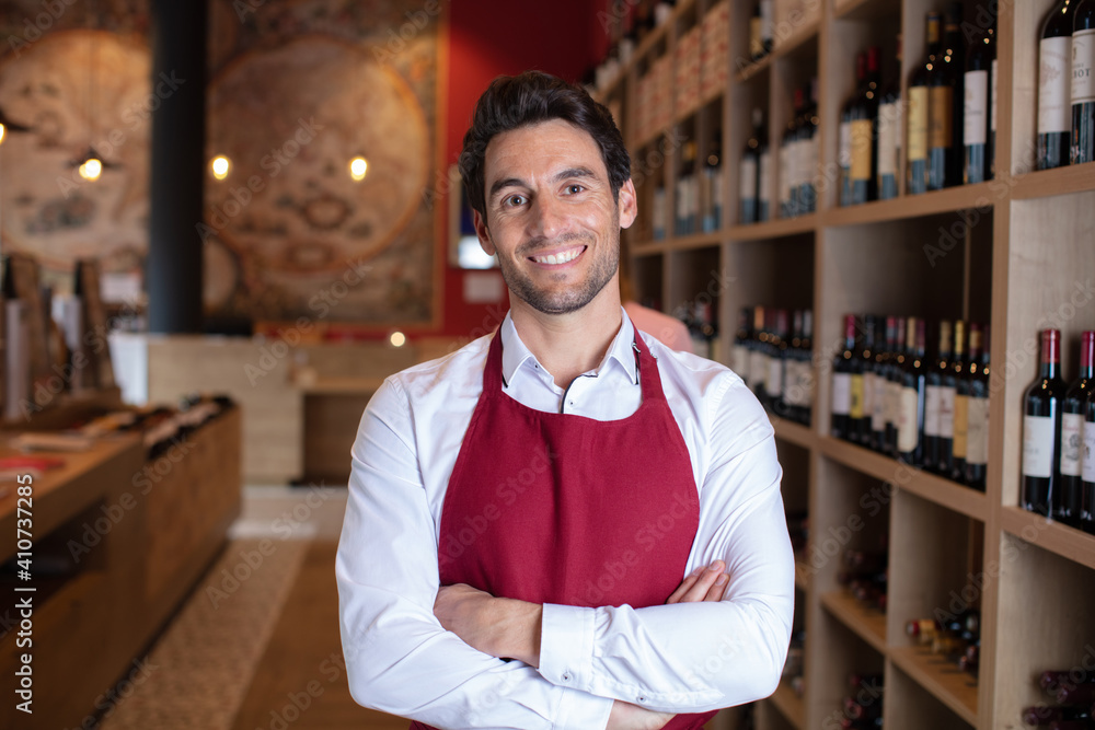 portrait of handsome sommelier in cellar portrait of handsome sommelier in cellar