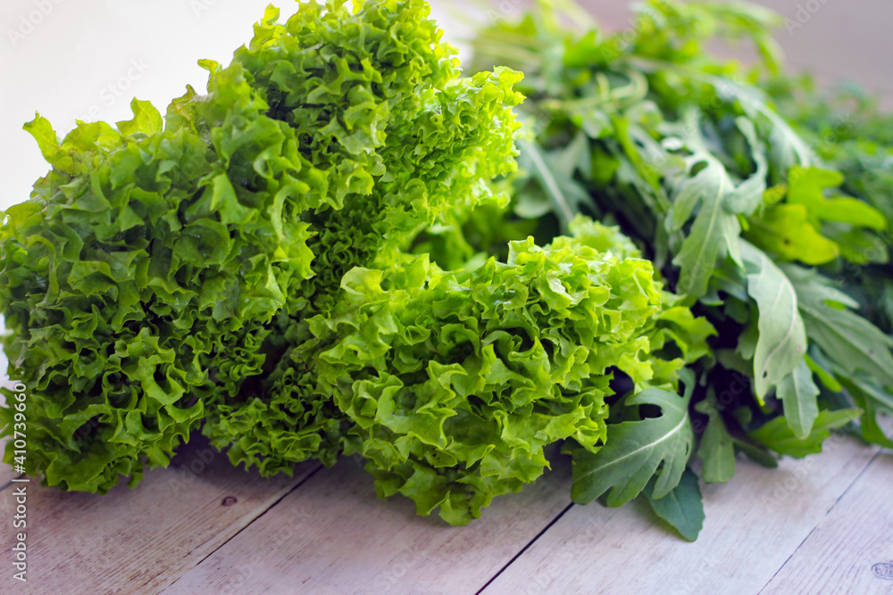 Green dill leaves and arugula on a wooden background Green dill leaves and arugula on a wooden background