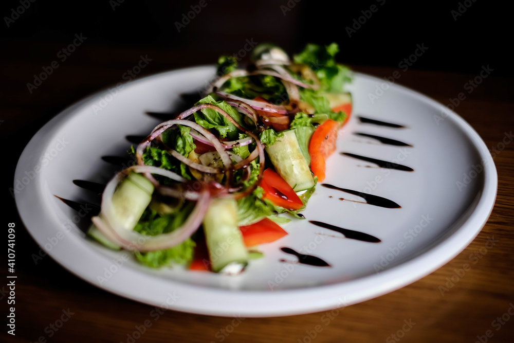 Fresh tasty Greek salad on dark background