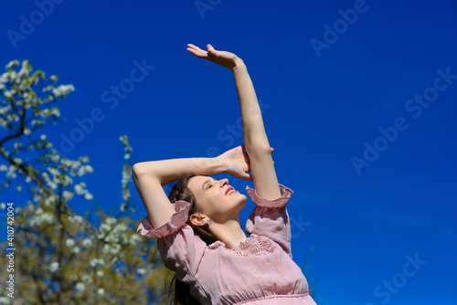 Woman happy smiling joyful with arms up dancing in summer during holidays travel