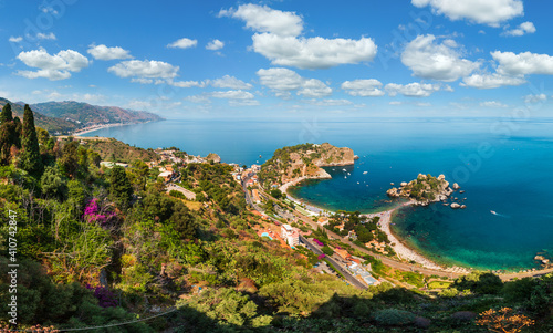 Fototapeta Naklejka Na Ścianę i Meble -  Beautiful Taormina panoramic view from up (Stairs to Taormina), Sicily, Italy. Sicilian seascape with coast, beaches and island Isola Bella. People unrecognizable.